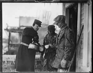Policeman gives firemen hot coffee in zero weather during Somerville fire (77-F)