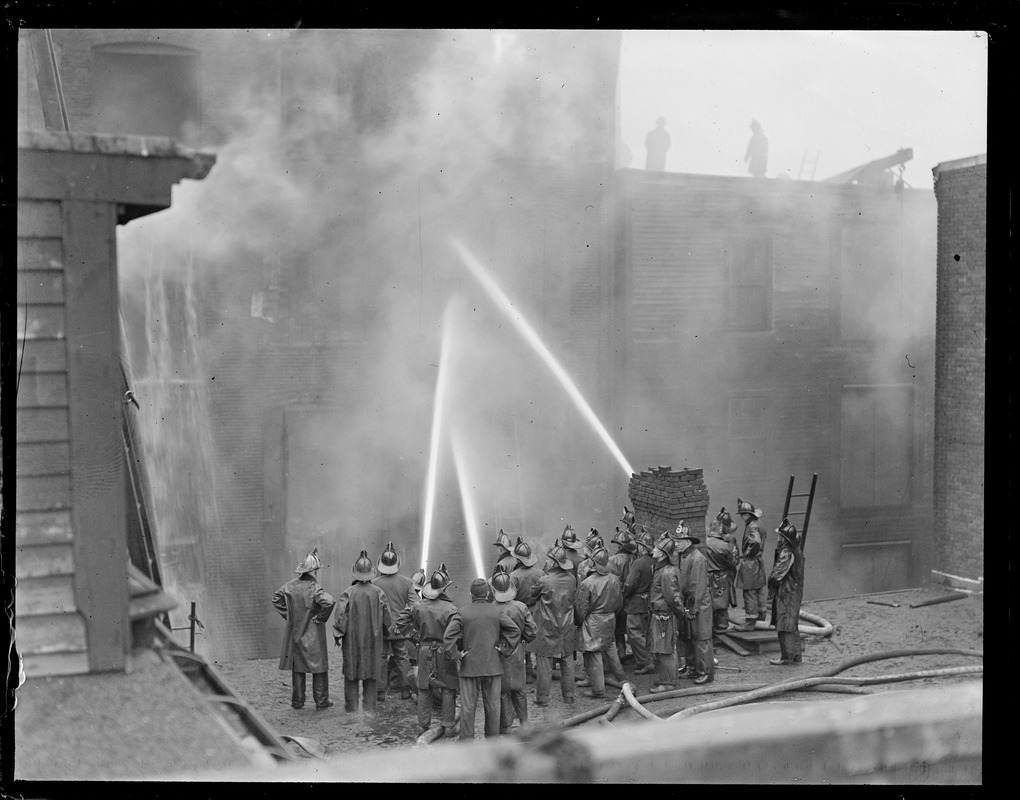 Fighting fire from roof of neighboring building