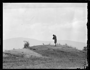 Woman photographing scenery with Graflex