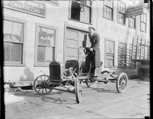 Prof. Leslie Jones rides unusual vehicle with Graflex in hand, at old T-wharf