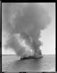 Steamer burning in Boston Harbor. Scrapping it.