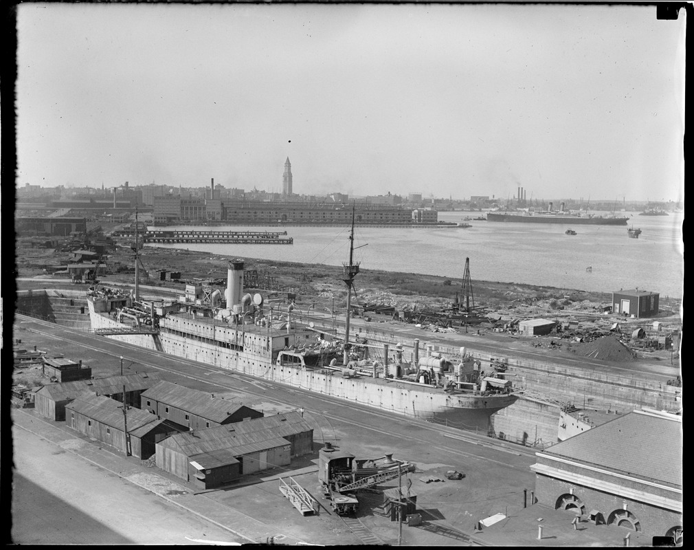 USS Bridgeport in drydock. SS Celtic in background.