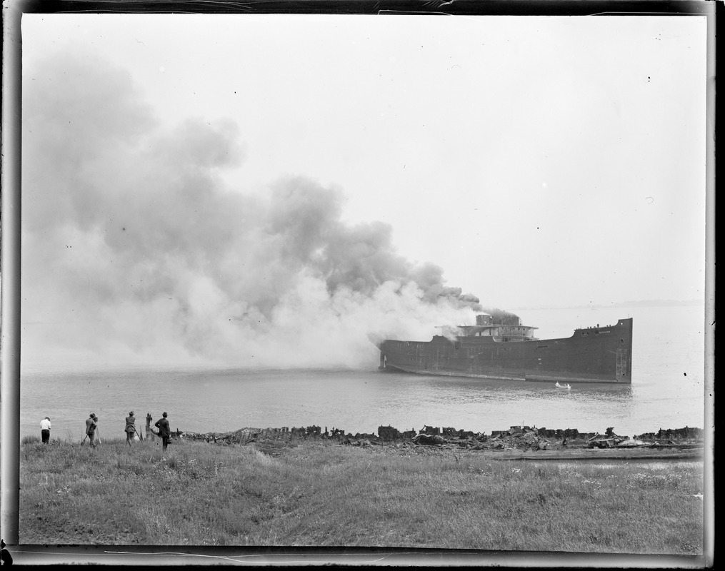 Ship burning in Boston Harbor. 'Wakanna' wooden ship off Apple Island. 'Scrapped'. Photographers on left.