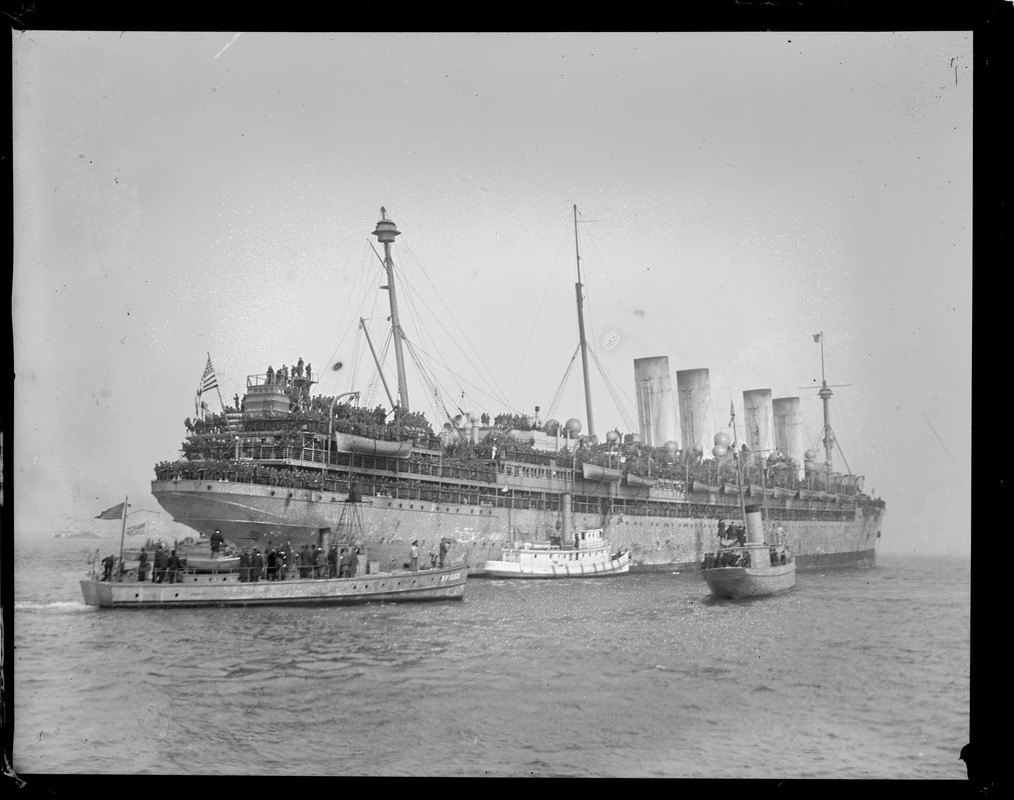 Four stacks. SS Agamemnon at anchor Boston Harbor, formerly the German Liner Kaiser Wilhelm II. Tonnage 22,622. She is 669 ft. long. 74 ft. wide, 47 ft. deep. Arrived April 7, 1919. Nearly 6000 brave heroes arrived on her from France.