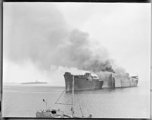SS Wakanna and SS Fairfield burn for junk off Governor's Island in Boston Harbor