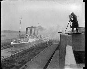 Movie operator Dick Sears nearly loses his life going for the best vantage point to film the SS Majestic as it sailed into the South Boston drydock. He almost fell off the army base roof a few minutes after the photo was taken.