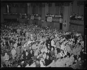 Audience with many uniformed military personnel in auditorium