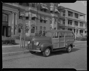 Studebaker wood-paneled station wagon outside The Breakers Hotel, Lynn, Massachusetts