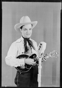 Unidentified man in cowboy outfit with mandolin