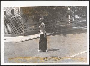 Young woman with a camera standing in the street