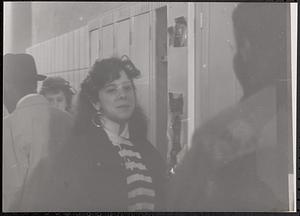 A young woman standing in front of lockers