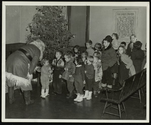 Children lined up to receive stocking from Santa