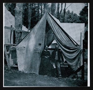 Two figures in tent at Asbury Grove