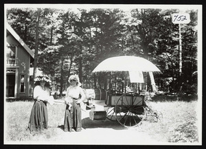 Two women in costume with vendor cart for parade, Asbury Grove, So. Hamilton, Mass