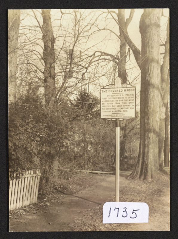 Sign in front of Cong. Church, Hamilton, the covered wagon