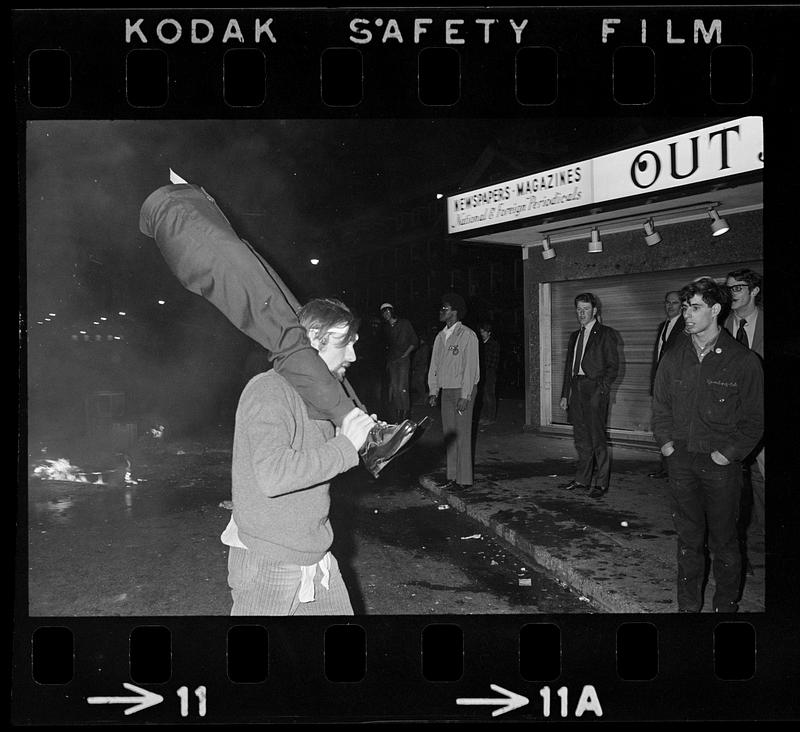 Harvard Square anti-war riot: Demonstrator & smashed store window dummy, Cambridge