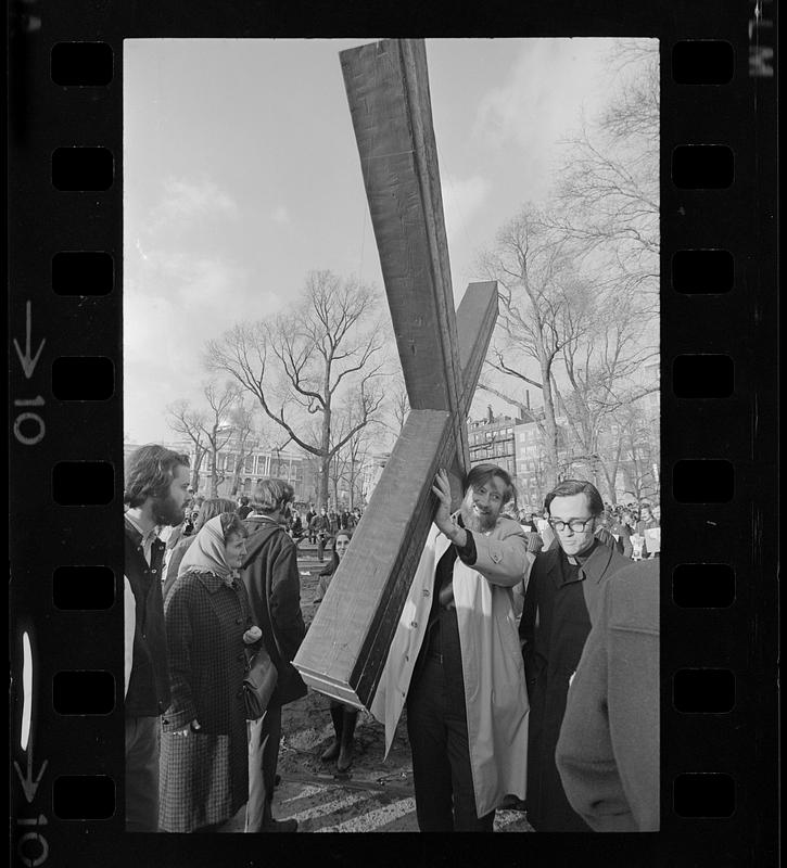 Anti-war demonstrator carries a cross, Boston Common