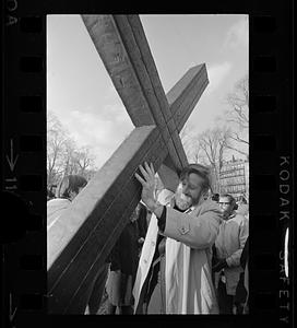 Anti-war demonstrator carries a cross, Boston Common