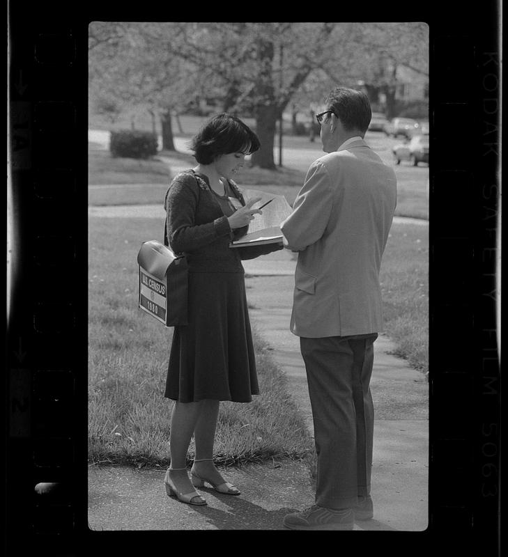 U.S. Census taker interviews man on street, Boston