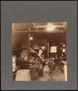 Edwin B. Macy at work in his blacksmith's shop