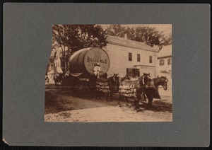 Giant keg labeled Roller Mills on carriage drawn by four horses wearing blankets advertising William Baylies Grain Co.
