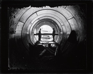 Two workers in a penstock