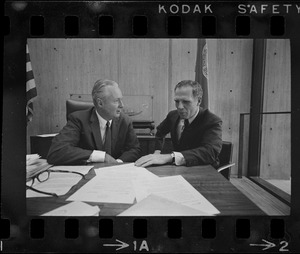 Mayor Collins, left, and Mayor-Elect White discuss city matters during the first meeting between the two at the new City Hall in the Government Center