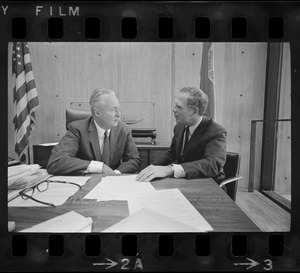 Mayor Collins, left, and Mayor-Elect White discuss city matters during the first meeting between the two at the new City Hall in the Government Center