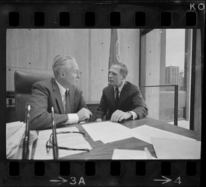 Mayor Collins, left, and Mayor-Elect White discuss city matters during the first meeting between the two at the new City Hall in the Government Center