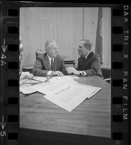 Mayor Collins, left, and Mayor-Elect White discuss city matters during the first meeting between the two at the new City Hall in the Government Center