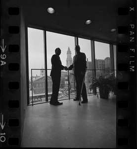 Mayor Collins, left, and Mayor-Elect White discuss city matters during the first meeting between the two at the new City Hall in the Government Center