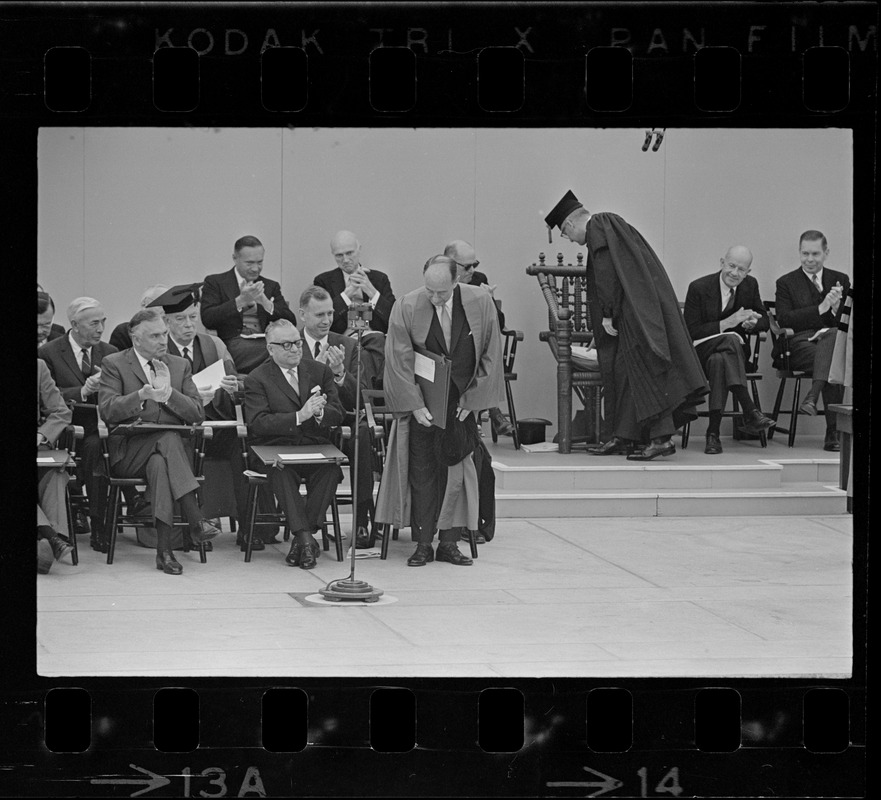 UN Envoy Adlai Stevenson accepts his honorary degree at Harvard Commencement. Seated are Galo Plaza, (left), Ecuador (seated left) and Romulo Betancourt of Venezuela