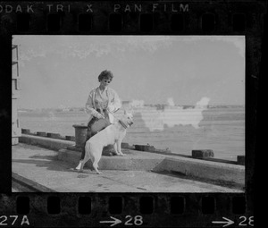 Unidentified woman with dog on South Boston Naval Annex dock