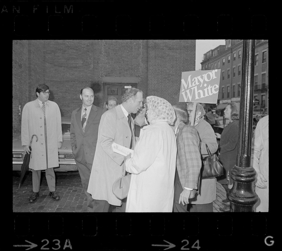 Boston Mayor Kevin White greets poll workers after casting ballots in the Boston mayoralty