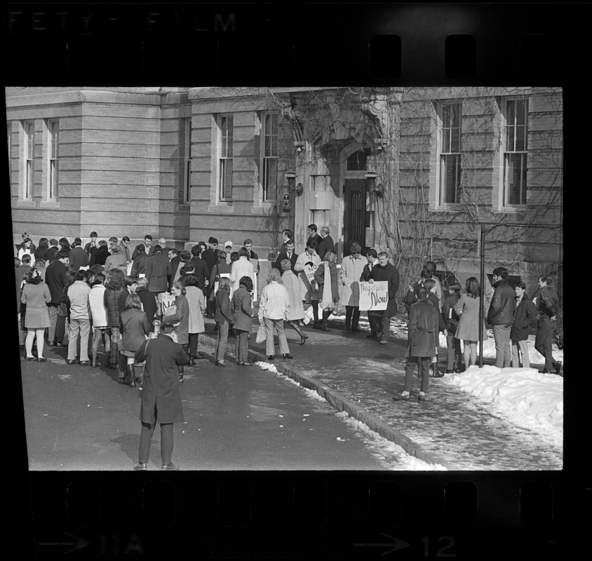 Students watch their teachers march the picket line outside of Woburn High School as the city's school teachers strike in defiance of a court order