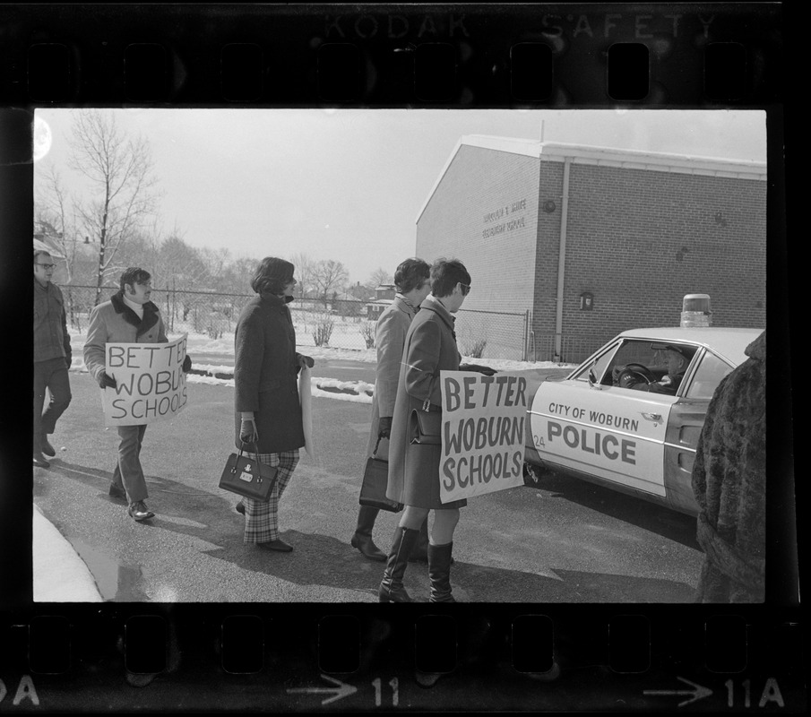 Striking schoolteachers call for "better Woburn schools" as they picket outside the Malcolm S. White Elementary School