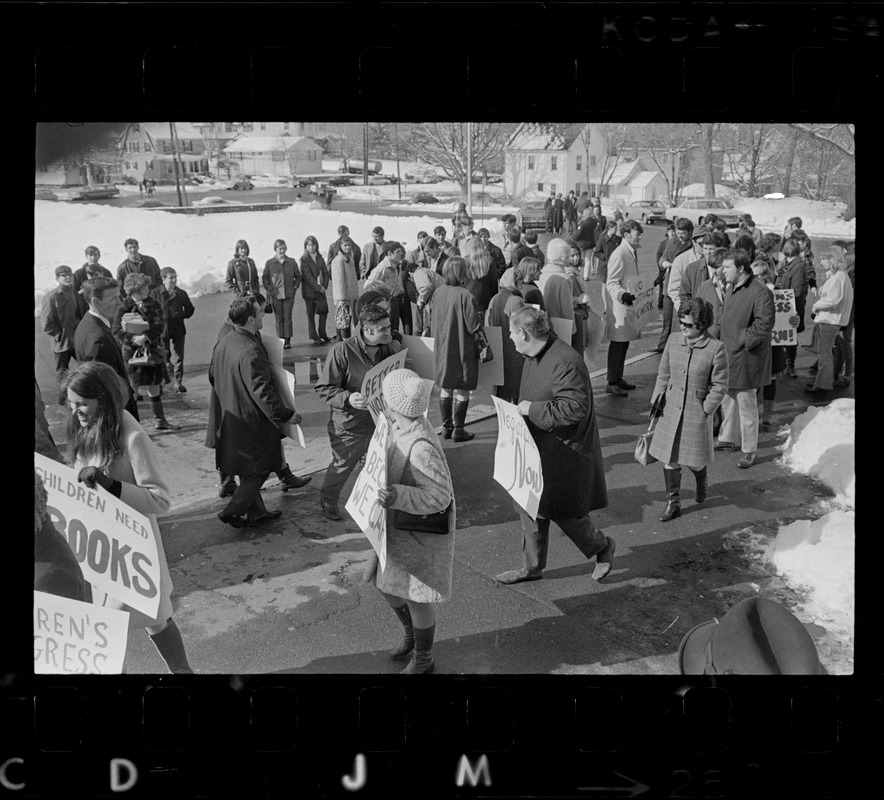 Students watch their teachers march the picket line outside of Woburn High School as the city's school teachers strike in defiance of a court order