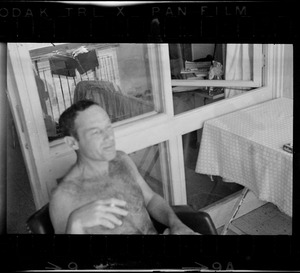 Unidentified man smoking on patio, Eilat, Israel