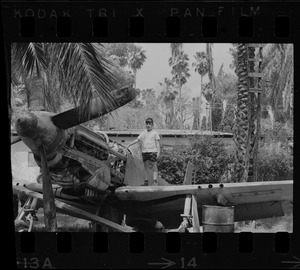 Boy posing on junked airplane, Israel