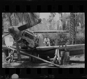 Boy posing on junked airplane, Israel