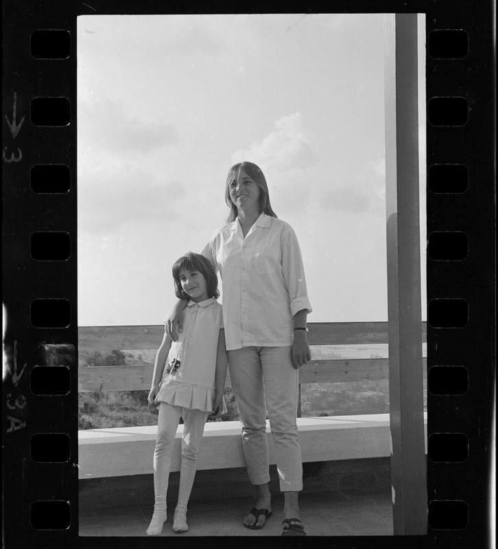 Woman and girl posing on patio, Israel