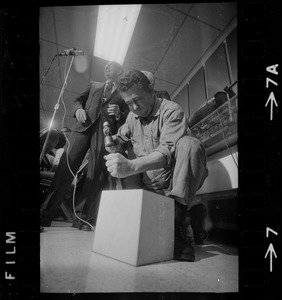 Man opening box of MBTA job applications as MBTA chair Robert C. Wood watches