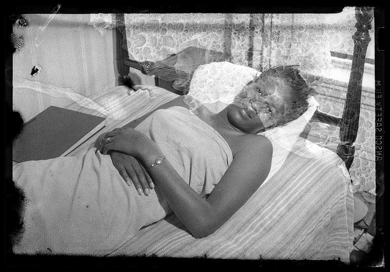 A woman lies down in a bed