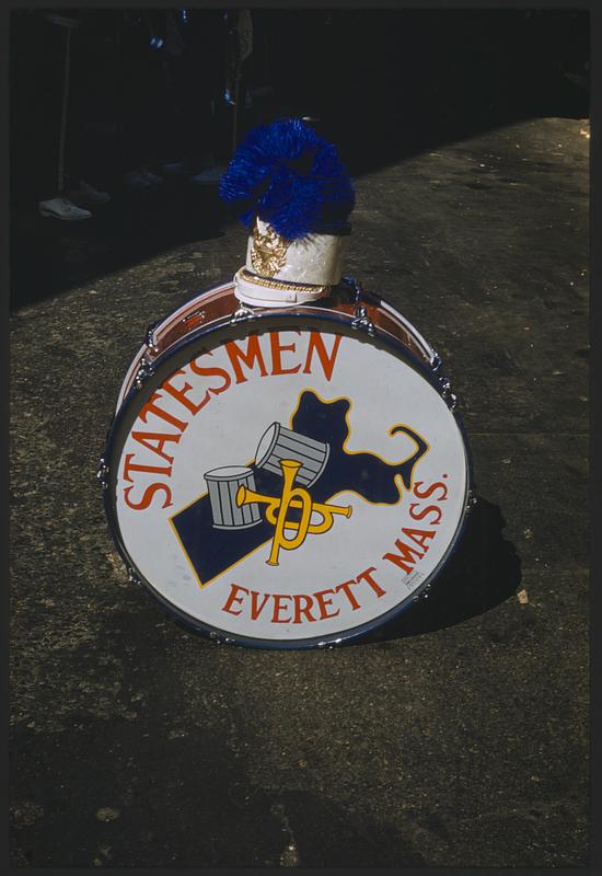 Marching band hat on bass drum labeled "Statesmen Everett Mass"
