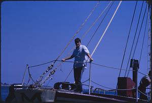 Man standing on a boat with rigging