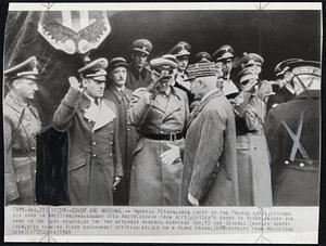 Vichy -- Envoy and Marshal -- Marshal Petain, aged Chief of the French State, extends his hand in greeting; Ambassador Otto Abetz (second from left), Hitler's Envoy to Vichy, raises his hand in The Nazi Salute, as the two attended funeral services Nov. 15 for General Charles Huntziger, High Ranking Vichy Government Official killed in a plane crash.