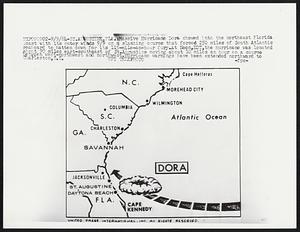 Massive Hurricane Dora chewed into the northeast Florida coast with its outer winds 9/9 on a slanting course that forced 250 miles of South Atlantic seaboard to batten down for its 115-mile-an-hour fury. At Noon, EDT, the hurricane was located about 90 miles east-southeast of St. Augustine moving about 10 miles an hour on a course between west-northwest and northwest. Hurricane warnings have been extended northward to Charleston, S.C.