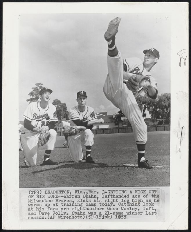 Getting A Kick Out Of His Work – Warren Spahn, lefthanded ace of the Milwaukee Braves, kicks his right leg high as he warms up at training camp today. Catching look at his form are righthanders Gene Conley, left and Dave Jolly. Spahn was a 21-game winner last season.