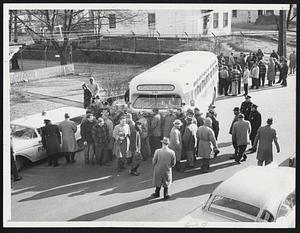 Buses Make Way Through Picket Line. One of seven Eastern Massachusetts Street Railway buses, inches its way through parading picket line in Brockton, Mass., January 5. The buses were prevented from picking up school children early in the morning but managed to make their way through the afternoon picket line, to carry out their assignments.