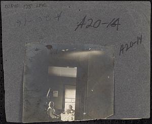 Elderly couple at table through doorway